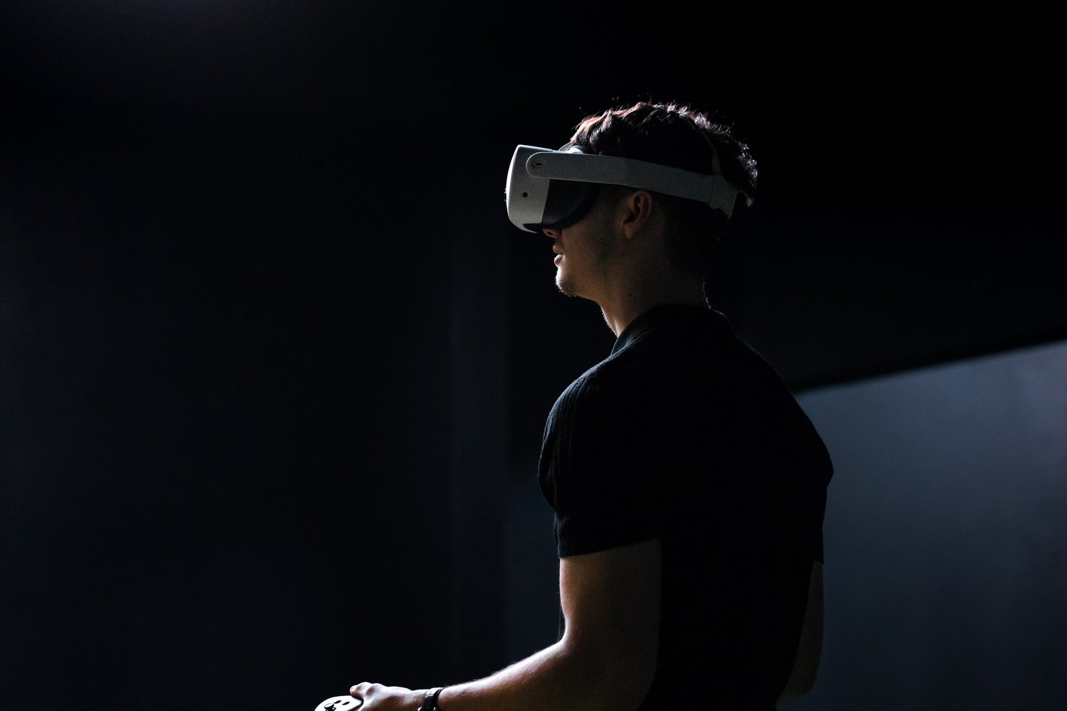 Person wearing a VR headset in a dark room